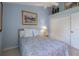 This is a shot of a bedroom with a light blue walls, closet and a window at 9019 Flagstick Ln, Hudson, FL 34667