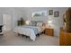 Bright bedroom with natural light, neutral carpeting, and a view of the backyard at 9019 Flagstick Ln, Hudson, FL 34667