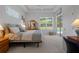 Comfortable bedroom with backyard pool views, ceiling fan and neutral decor at 9019 Flagstick Ln, Hudson, FL 34667