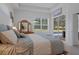 Relaxing bedroom featuring pool views, neutral paint and decor, and comfortable bedding at 9019 Flagstick Ln, Hudson, FL 34667