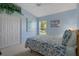Light and bright bedroom with blue walls, white trim and vaulted ceiling at 9019 Flagstick Ln, Hudson, FL 34667