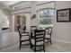 Bright breakfast nook with a view of the screened-in pool area through a large window at 9019 Flagstick Ln, Hudson, FL 34667