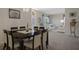 Dining room showcasing a dark wood table with seating for eight and a view of the living room at 9019 Flagstick Ln, Hudson, FL 34667