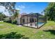 Charming home featuring a screened-in pool area, blending indoor and outdoor living seamlessly at 9019 Flagstick Ln, Hudson, FL 34667