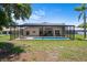 Beautiful backyard with a screened-in pool, offering a private oasis for relaxation and recreation at 9019 Flagstick Ln, Hudson, FL 34667