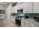 Updated kitchen with stainless steel appliances, granite countertops, and white cabinetry at 9019 Flagstick Ln, Hudson, FL 34667