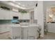 Bright kitchen featuring an island, granite countertops, stainless steel appliances, and tiled backsplash at 9019 Flagstick Ln, Hudson, FL 34667