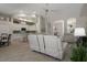 Open-concept living area with leather furniture, connecting to the kitchen and dining spaces at 9019 Flagstick Ln, Hudson, FL 34667