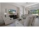 Comfortable living room featuring reclining sofas, a modern TV, and a bright, airy feel at 9019 Flagstick Ln, Hudson, FL 34667
