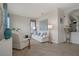 Bright living room with tiled floors, white sofa and chairs, and decor at 9019 Flagstick Ln, Hudson, FL 34667