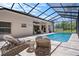 Inviting screened-in pool area with comfortable lounge chairs, perfect for relaxation and entertaining at 9019 Flagstick Ln, Hudson, FL 34667