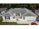 Aerial view showcases a single-Gathering home with a grey roof and a gated front patio at 9116 Gray Fox Ln, Port Richey, FL 34668