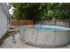 Backyard features above-ground pool with a decorative donut float for added fun at 9116 Gray Fox Ln, Port Richey, FL 34668