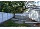Backyard showcasing an above-ground pool with white privacy fencing and partial grass coverage at 9116 Gray Fox Ln, Port Richey, FL 34668
