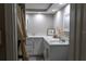 Bathroom with white cabinets, neutral countertops, and decorative mirror at 9116 Gray Fox Ln, Port Richey, FL 34668
