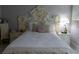 Comfortable bedroom with ornate headboard, side tables, and decorative pillows at 9116 Gray Fox Ln, Port Richey, FL 34668