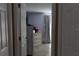 View of a bedroom through a doorway featuring neutral decor and tiled floors at 9116 Gray Fox Ln, Port Richey, FL 34668