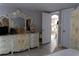 Bedroom featuring ornate dresser, plenty of natural light, and adjoining rooms at 9116 Gray Fox Ln, Port Richey, FL 34668