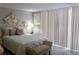 Cozy bedroom with decorative headboard and lots of natural light at 9116 Gray Fox Ln, Port Richey, FL 34668