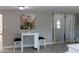 Bright dining area with white table, two chairs, and decorative floral artwork at 9116 Gray Fox Ln, Port Richey, FL 34668
