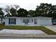 Charming single-story home with white exterior, well-maintained landscaping, and an attached garage at 9116 Gray Fox Ln, Port Richey, FL 34668