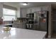Modern kitchen featuring quartz countertops, stainless steel appliances, and white cabinets at 9116 Gray Fox Ln, Port Richey, FL 34668