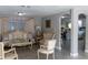 Well-lit living room featuring elegant furniture, neutral paint, and tile flooring at 9116 Gray Fox Ln, Port Richey, FL 34668
