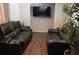 Spacious living room with a flat-screen TV, comfortable seating and modern decor at 9116 Gray Fox Ln, Port Richey, FL 34668