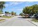 Neighborhood street view with houses, trees, cars parked along the sides, and palm trees at 9116 Gray Fox Ln, Port Richey, FL 34668