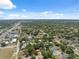 Wide aerial view of a neighborhood with mature trees and a clear blue sky at 9306 21St, Tampa, FL 33612