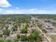 An aerial view of the neighborhood features residential properties nestled among lush greenery with sunny skies above at 9306 21St, Tampa, FL 33612