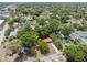 This high-angle showcases the property featuring a red roof, lush surroundings, and a serene residential neighborhood at 9306 21St, Tampa, FL 33612