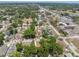 This aerial shot reveals a vibrant neighborhood near amenities and roads with mature trees that shade the homes at 9306 21St, Tampa, FL 33612