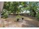 Spacious backyard featuring a wooden fence and mature trees offering ample shade and privacy at 9306 21St, Tampa, FL 33612