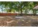 Large backyard with mature trees and a patio area with a grill, perfect for entertaining at 9306 21St, Tampa, FL 33612