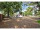 Expansive backyard featuring a small patio and mature trees, perfect for relaxation and outdoor entertaining at 9306 21St, Tampa, FL 33612