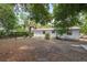 Large backyard, with a backdrop of a red roof and mature trees creating a serene outdoor space at 9306 21St, Tampa, FL 33612
