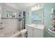 Bathroom featuring a shower with tile surround and a vanity with storage at 9306 21St, Tampa, FL 33612
