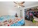 Comfortable bedroom featuring a ceiling fan and closet with ample storage space at 9306 21St, Tampa, FL 33612