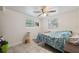 Simple bedroom with tile flooring, neutral walls, and two windows offering natural light at 9306 21St, Tampa, FL 33612