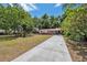 Beautiful home with a red roof, complemented by a spacious driveway and lush front yard landscaping at 9306 21St, Tampa, FL 33612