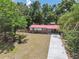 Charming home with a red roof, a long driveway, and a well-maintained front yard at 9306 21St, Tampa, FL 33612