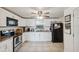 Updated kitchen featuring granite countertops, stainless steel appliances, and white cabinetry at 9306 21St, Tampa, FL 33612