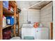 Functional laundry room with washer, dryer, and storage shelves at 9306 21St, Tampa, FL 33612