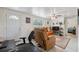 Cozy living room featuring neutral tile flooring, a comfortable leather recliner, and lots of natural light at 9306 21St, Tampa, FL 33612