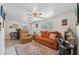 Bright living room with an area rug, tile floors, a comfortable orange sofa set, and lots of natural light at 9306 21St, Tampa, FL 33612