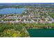 An aerial view showing the property's location within a beautiful community near a lake, surrounded by lush greenery at 9729 Bay Colony Dr, Riverview, FL 33578