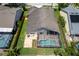 A high-angle aerial view of the property with the screened-in pool, backyard, and proximity to other homes at 9729 Bay Colony Dr, Riverview, FL 33578