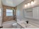Bathroom featuring shower and soaking tub with a large vanity and a window at 9729 Bay Colony Dr, Riverview, FL 33578
