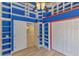 Bedroom with custom shelving and wood-look floors at 9729 Bay Colony Dr, Riverview, FL 33578